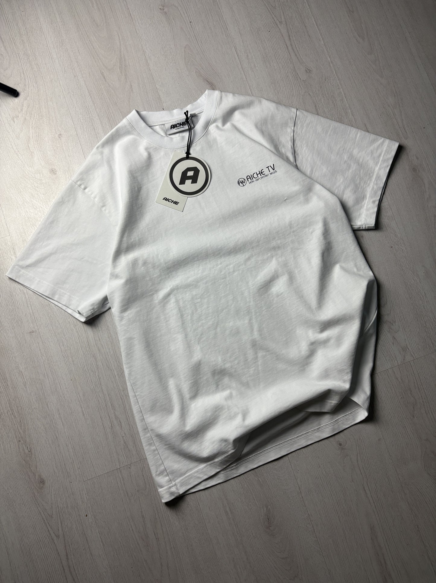 📺 Aiche T-Shirt Wit “Aiche TV” – Extra Large